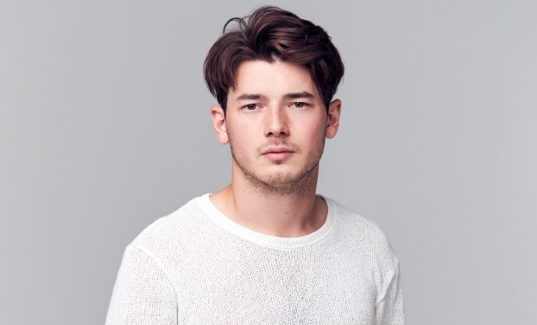 Studio Portrait Of Young Man With Serious 8YSPPQM